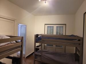 a room with two bunk beds and a mirror at LES TERRASSES DE L'ALLIER in Monistrol-dʼAllier