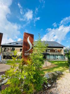 a building with a sap sign in front of it at Aparthotel Siente Boí & SPA in Pla de l'Ermita
