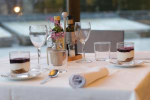 a table with four wine glasses on a table at Aparthotel Siente Boí & SPA in Pla de l'Ermita