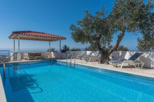 a swimming pool in a villa with a tree at Apartment Glavina with private pool in Makarska