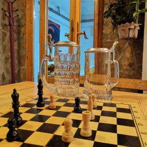 a chessboard and a glass vase on a table at Vikendica Ole Apartman 2. in Pale