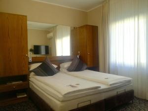 Postel nebo postele na pokoji v ubytování Top Hotel Krämer