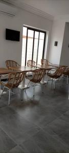 a group of tables and chairs in a room at Hôtel Marbella in Lomé