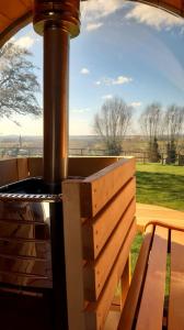 a woodburning stove with a bench in front of a window at De Rieke in Ronse