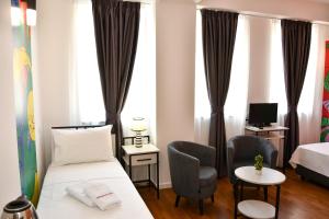 Postel nebo postele na pokoji v ubytování Osten Art Hotel