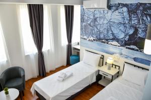Postel nebo postele na pokoji v ubytování Osten Art Hotel