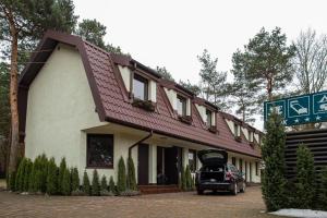 a car parked in front of a building at Camping Motel WOK in Warsaw