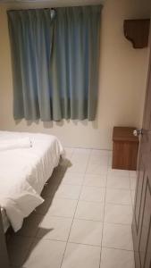 Voodi või voodid majutusasutuse Pangkor staycation apartment toas