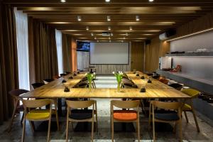 a large conference room with a large wooden table and chairs at Hotel Novy Kastiel - Self check-in in Topoľčany