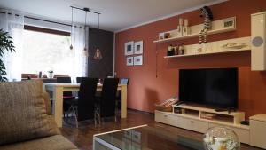 a living room with a dining table and a television at Ferienwohnung Weirich in Moselkern