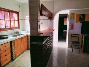 a kitchen with a sink and a counter top at Hostel Joy in El Bolsón