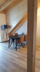 a dining room with a black table and chairs at Ferienapartment bavarian living in Moosinning