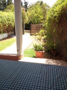 a porch with a checkered floor in a yard at Casa Marisa in Conil de la Frontera