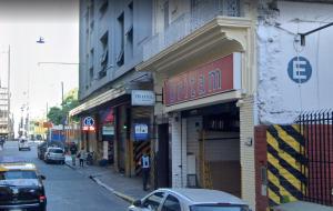 a street with cars parked in front of buildings at Hotel La Piedad in Buenos Aires