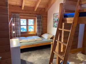 a bedroom with a bunk bed and a ladder at Ferienhaus Wilder Kaiser in Kiefersfelden