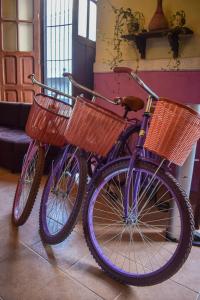 two purple bikes with baskets parked in a room at Hotel Santa Ana in Mérida