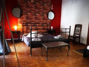 a bedroom with a bed and a brick wall at Duque de conventus in Lisbon