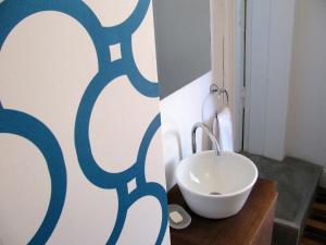a bathroom with a white sink in a room at 06 Soho Suites in Buenos Aires