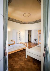 a bedroom with two bunk beds and wooden floors at Villa Schmidt in Pirna
