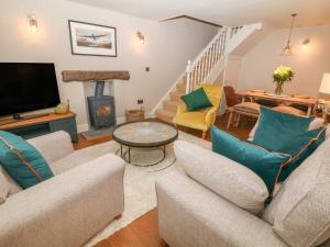a living room with two couches and a tv at Brookhouse in Castleton