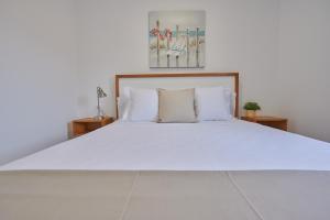 a large white bed with two pillows on it at ABLANCAS - La Restinga in La Restinga