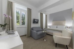 Postel nebo postele na pokoji v ubytování Aminess Younique Bellevue Hotel