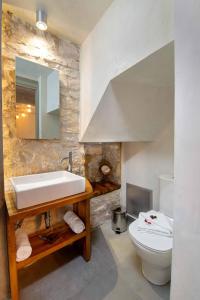 a bathroom with a sink and a toilet at Lakka Stone House 0 in Gaios