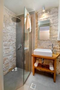 a bathroom with a sink and a shower at Lakka Stone House 0 in Gaios