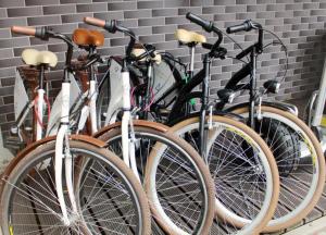 a group of bikes lined up against a wall at Apartamenty Planeta Mielno in Mielno