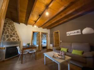 a living room with a couch and a fireplace at Casa Serapio in Ávila