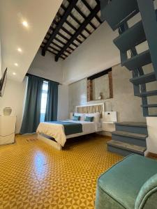 a bedroom with a bed and stairs in a room at Mosquito Boutique Hotel Zona Colonial in Santo Domingo