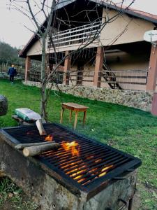 a grill with a bunch of hot dogs on it at Pensiunea La Buru in Căraciu