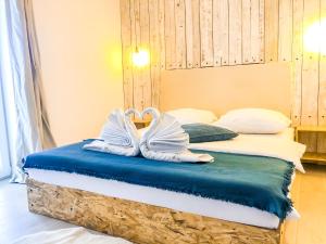 a pair of white shoes sitting on top of a bed at Kisas Loft By Pinch in Pakoštane