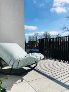 a bed sitting on top of a patio at Suites Le Porte-Bonheur in Bruges