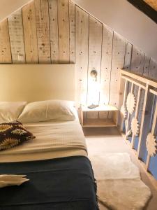a bedroom with a bed with a wooden wall at Kisas Loft By Pinch in Pakoštane
