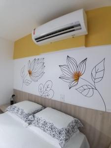 a bedroom with a wall with flowers painted on it at Smart Residence Flat - FLAT 605 in Teresina