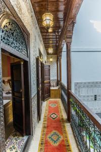 a hallway of a building with a rug on the floor at Riad Atlas Mejbar in Marrakesh