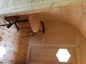 a ceiling in a log cabin with a ceiling fan at Framtid Camping Lodging Barrels in Djúpivogur