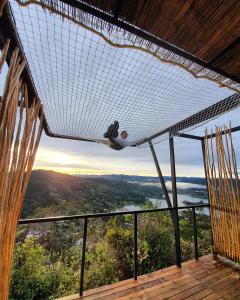 a net in a room with a view of a valley at Glamping La Montaña Sagrada in Medellín