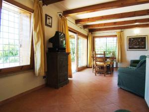 a living room with a couch and a tv at Villa Raggio Di Sole in Porto Santo Stefano
