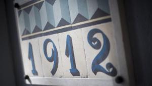 a close up of a wooden block with the number at Aminess Younique Korcula Heritage Hotel in Korčula