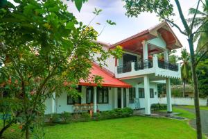 una casa con techo rojo y patio en Sapumal Lodge en Anuradhapura