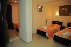 a hotel room with two beds in a room at Hotel San Antonio in Paralia Katerinis