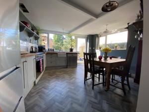 a kitchen with a table and chairs and a table and a kitchen with at Pillar House in Cockermouth