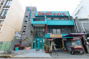 a building with a red door on a street at RedDoorz Plus @ Danlig Street Makati in Manila