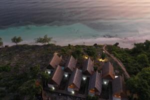an aerial view of a building on a hill next to the ocean at Paduppa Resort in Bira +6 photos