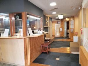 a lobby of a restaurant with a counter at Tsukuba Daily Inn in Tsukuba