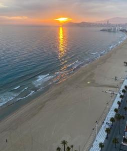 an aerial view of the beach at sunset at Apartments Torre Levante 1H in Benidorm