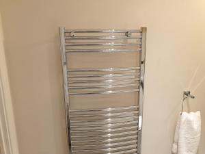 a metal towel rack in a white wall at Birmingham Amethyst, 3 bedroom Apartment in Birmingham +46 photos