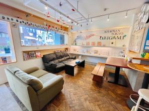 a living room filled with furniture and a large window at Khaosan Tokyo Origami in Tokyo